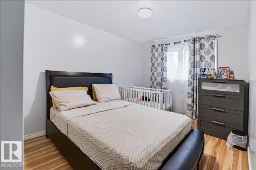 Wood-finish flooring, white walls, and a ceiling-mounted light fixture - 12919 135 Avenue Nw, Edmonton, AB 