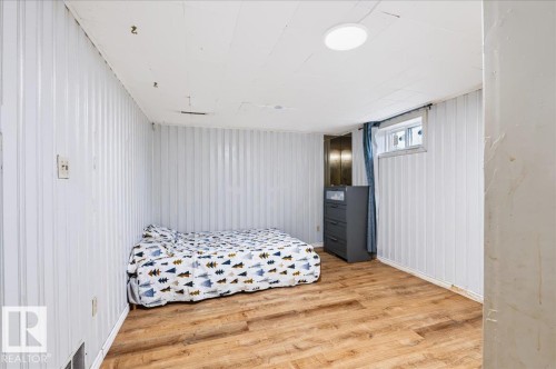 Wood-finish flooring, white paneled walls, and a recessed ceiling light - 12919 135 Avenue Nw, Edmonton, AB 