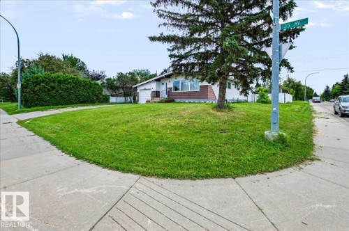 Single-story residence with white siding and brown accent panels - 12919 135 Avenue Nw, Edmonton, AB 