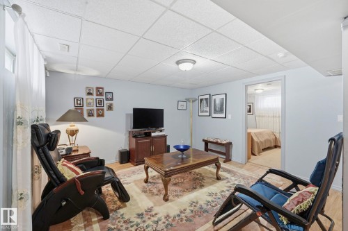 Recessed ceiling with flush mount lighting, light-toned walls, and wood-finish flooring - 3231 28A Avenue Nw, Edmonton, AB 
