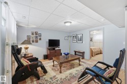 Recessed ceiling with flush mount lighting, light-toned walls, and wood-finish flooring - 