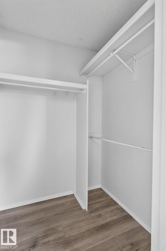 Spacious closet with white walls and wood-finish flooring - 3722 34A Avenue Nw, Edmonton, AB - Indoor With Storage