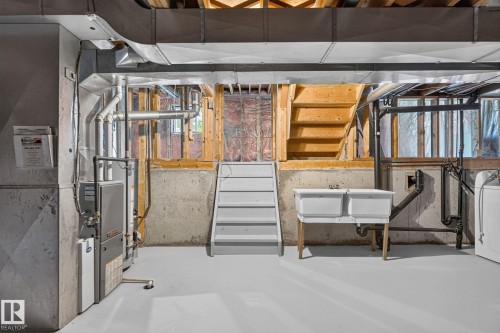 Unfinished basement space featuring a utility sink, concrete foundation, exposed wooden beams, and a furnace unit - 3722 34A Avenue Nw, Edmonton, AB - Indoor Photo Showing Other Room