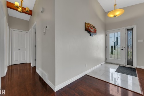 Entryway with leaded glass front door, side panel, and white tile flooring - 8803 68A Street Nw, Edmonton, AB 