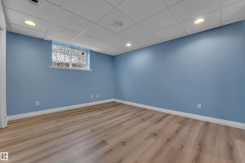Recessed lighting, wood-finish flooring, drop ceiling, and a glass block window - 8803 68A Street Nw, Edmonton, AB 