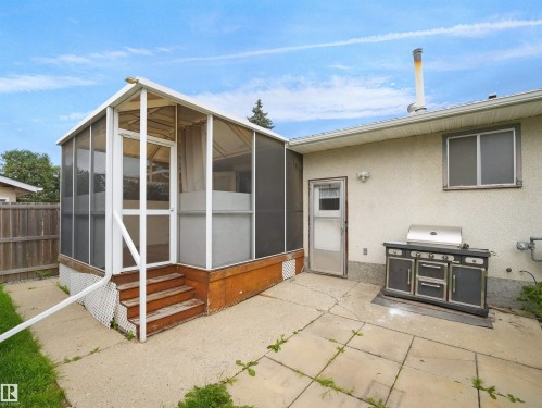 Screened structure with wooden steps and a concrete patio surface - 7435 32 Avenue Nw, Edmonton, AB 