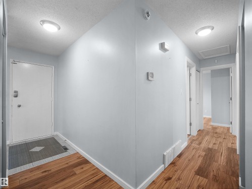 Wood-finish flooring throughout, with a tiled entry area - 7435 32 Avenue Nw, Edmonton, AB 