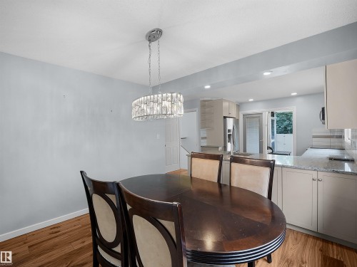 Wood-finish flooring, recessed lighting, and a crystal chandelier - 7435 32 Avenue Nw, Edmonton, AB 