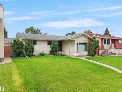 Cream-colored siding exterior with a dark roof - 7435 32 Avenue Nw, Edmonton, AB 