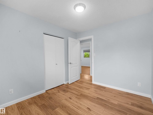 Wood-finish flooring with white trim - 7435 32 Avenue Nw, Edmonton, AB 