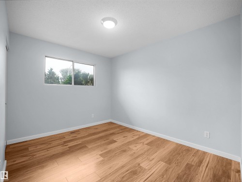 Hardwood-finish flooring, white walls, and a flush mount ceiling light - 7435 32 Avenue Nw, Edmonton, AB 