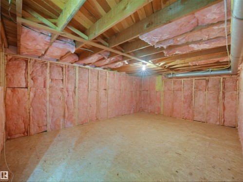 Unfinished space featuring wood framing, exposed wood ceiling joists, and insulated walls - 7435 32 Avenue Nw, Edmonton, AB 