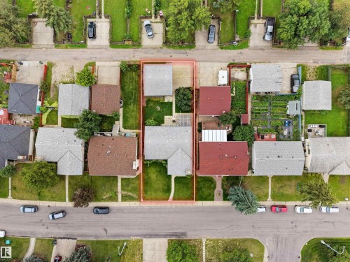 Property with two distinct structures, featuring a front yard with mature landscaping and a paved driveway - 7435 32 Avenue Nw, Edmonton, AB 