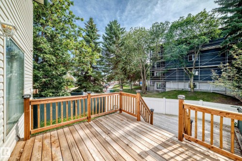 Spacious wood-finish deck with natural wood railings and solar post caps - #30 300 Hooper Cr Nw, Edmonton, AB 