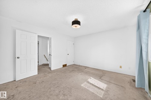 Neutral wall palette, flush mount ceiling light, paneled interior doors, and carpeted flooring - #30 300 Hooper Cr Nw, Edmonton, AB 