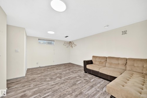 Recessed lighting fixtures, wood-finish flooring, and a single window with horizontal blinds - #30 300 Hooper Cr Nw, Edmonton, AB 