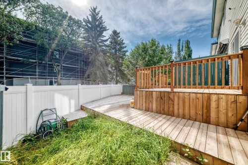 Raised wooden deck with a matching wood-finish railing - #30 300 Hooper Cr Nw, Edmonton, AB 