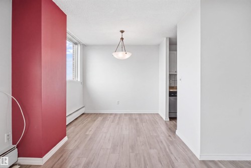 Wood-finish flooring, overhead lighting fixture, and a window with a white frame - #1115 13910 Stony Plain Rd Nw, Edmonton, AB 