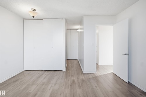 Recessed lighting, wood-finish flooring, white walls, and built-in closet storage - #1115 13910 Stony Plain Rd Nw, Edmonton, AB 