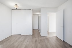 Recessed lighting, wood-finish flooring, white walls, and built-in closet storage - 