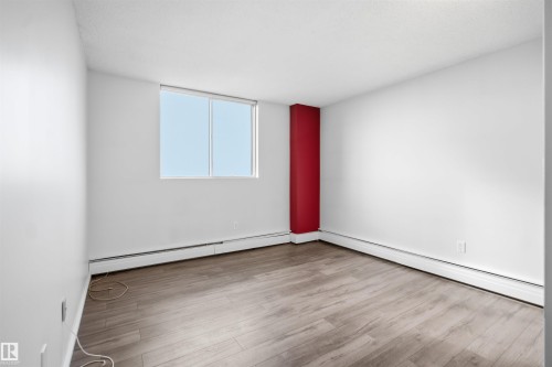Wood-finish flooring with white walls and a red accent column - #1115 13910 Stony Plain Rd Nw, Edmonton, AB 
