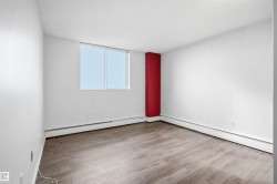 Wood-finish flooring with white walls and a red accent column - 