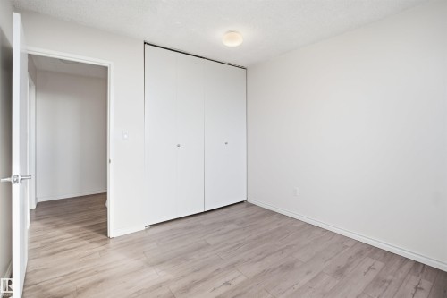 Wood-finish flooring, white walls, and a flush-mount ceiling light - #1115 13910 Stony Plain Rd Nw, Edmonton, AB 