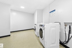 Laundry area with two front-loading machines and tile flooring - 