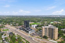 Aerial perspective showcasing surrounding urban landscape with multiple high-rise structures - 