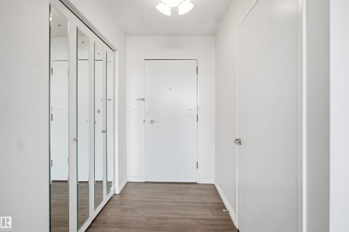 Wood-finish flooring, mirrored closet doors, and recessed lighting - #1115 13910 Stony Plain Rd Nw, Edmonton, AB 