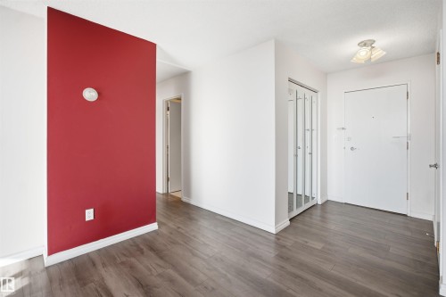 Wood-finish flooring, accent wall, mirrored closet doors, and recessed lighting - #1115 13910 Stony Plain Rd Nw, Edmonton, AB 