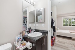 Vanity with undermount sink, dark cabinetry, and integrated mirror - 