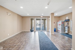 Tiled flooring with a neutral wall palette, recessed ceiling lighting, and glass entry doors - 