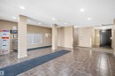 Tiled flooring with a neutral color palette, recessed lighting, and a mail area with individual mailboxes - #212 12035 22 Av Sw, Edmonton, AB 