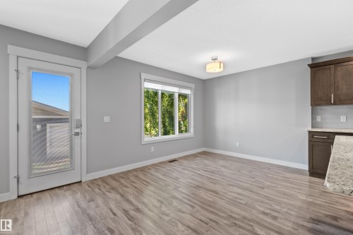 Wood-finish flooring, white trim, recessed lighting, white ceiling, and a large window - 2585 Pegasus Boulevard Nw, Edmonton, AB 