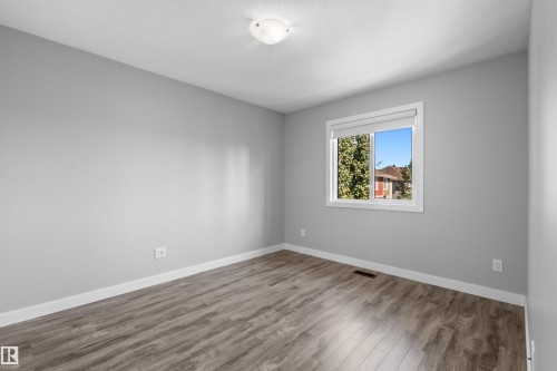 Wood-finish flooring with white trim and a single window - 2585 Pegasus Boulevard Nw, Edmonton, AB 