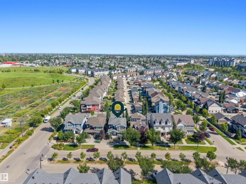 Aerial perspective showcasing a residential area with diverse architectural styles, adjacent green spaces, and a clear sky backdrop - 2585 Pegasus Boulevard Nw, Edmonton, AB 