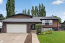 Stucco exterior with a prominent single-car garage and a paved driveway - 131 Pine Drive, Wetaskiwin, AB  - Outdoor 
