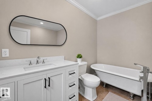 Bathroom featuring a white vanity with black hardware, a rectangular undermount sink, and a white countertop - 131 Pine Drive, Wetaskiwin, AB - Indoor Photo Showing Bathroom