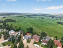 Property featuring a gray shingled roof, light-toned siding, and a paved driveway - 131 Pine Drive, Wetaskiwin, AB  - Outdoor With View 
