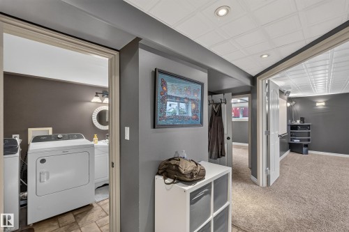 Hallway featuring recessed lighting, textured ceiling panels, and neutral wall tones - 131 Pine Drive, Wetaskiwin, AB - Indoor Photo Showing Laundry Room