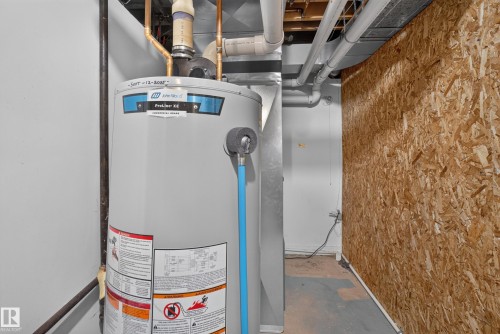Commercial-grade water heater with visible copper piping and ductwork - 131 Pine Drive, Wetaskiwin, AB - Indoor Photo Showing Basement
