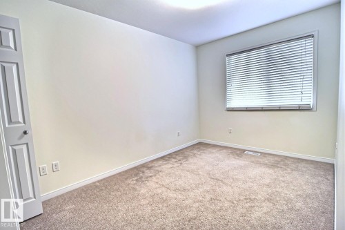 Neutral wall paint, plush carpet flooring, recessed ceiling lighting, and a window with horizontal blinds - #18 4850 Terwillegar Cm Nw, Edmonton, AB 