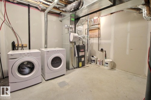 Concrete flooring, drywall walls, exposed ceiling utilities, installed washer, installed dryer - #18 4850 Terwillegar Cm Nw, Edmonton, AB 