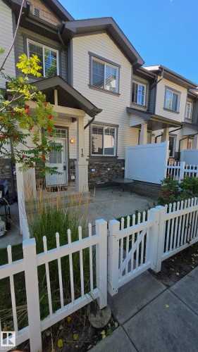 Multilevel exterior with light siding and stone-finish accents - #18 4850 Terwillegar Cm Nw, Edmonton, AB 