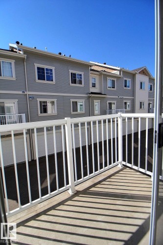 Private balcony with a white railing - #18 4850 Terwillegar Cm Nw, Edmonton, AB 