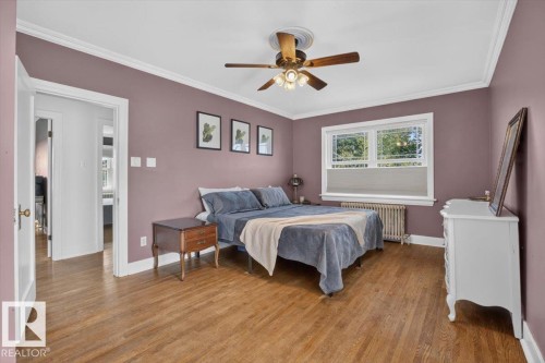 Hardwood flooring, crown molding, white trim, ceiling fan, and a large window - 17107 80 Avenue Nw, Edmonton, AB 
