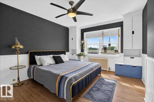 Hardwood-style flooring, white wainscoting, built-in cabinetry, and a ceiling fan with integrated lighting - 17107 80 Avenue Nw, Edmonton, AB 
