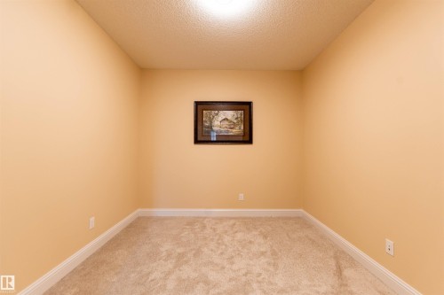Carpeted flooring, neutral wall paint, and white trim - 1419 Chahley Place Nw, Edmonton, AB 