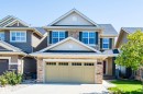 Two-story exterior with stone and siding accents, prominent gable roofs, and an attached two-car garage - 1419 Chahley Place Nw, Edmonton, AB 